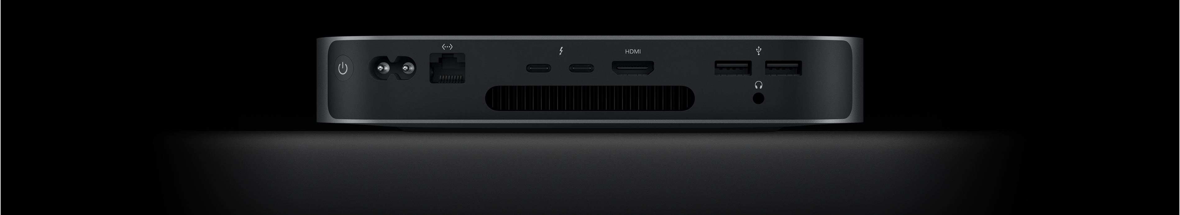Mac mini’nin iki adet Thunderbolt 4 bağlantı noktasını, HDMI bağlantı noktasını, iki adet USB-A bağlantı noktasını, kulaklık jakını, Gigabit Ethernet bağlantı noktasını, güç bağlantı noktasını ve güç düğmesini gösteren arkadan görünümü.